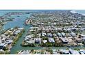 Waterfront home surrounded by lush tropical greenery, offering direct access to the Gulf of Mexico at 244 Willow Ave, Anna Maria, FL 34216