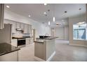 Modern kitchen with granite countertops, stainless steel appliances, tile backsplash, and ample cabinet space at 271 Petrel Trl, Bradenton, FL 34212