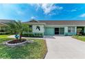 Well-maintained single-story home with manicured lawn, two-car garage, and charming curb appeal at 3009 Live Oak Ln # 33, Palmetto, FL 34221