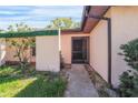 Inviting front entrance with a screened door, landscaping, and a walkway leading to the front door at 314 Signorelli Dr, Nokomis, FL 34275