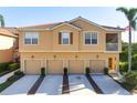 Beautiful multi-Gathering home exterior showing tan color scheme, garages, and tile roof at 3456 Parkridge Cir # 33-105, Sarasota, FL 34243