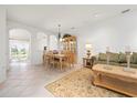 Bright living area with tiled floors, and a dining set, perfect for comfortable living and entertaining guests at 3456 Parkridge Cir # 33-105, Sarasota, FL 34243