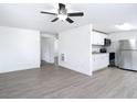 Open-concept living space featuring modern flooring and white wall paint at 3512 N 10Th St, Tampa, FL 33605