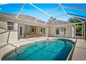Relaxing screened-in pool area perfect for outdoor entertaining with comfortable seating at 3528 Monday Ter, North Port, FL 34286