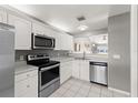 Well-lit kitchen features stainless steel appliances, white cabinets, and an open layout at 3605 60Th W St, Bradenton, FL 34209