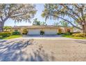 Exterior view of charming side-by-side homes with mature trees and a well-kept lawn at 4058 Oakhurst Dr # 3174, Sarasota, FL 34233