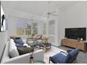 Bright living room with stylish furniture, ceiling fans, and large windows at 4110 Central Sarasota Pkwy # 135, Sarasota, FL 34238