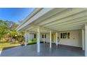 View of the carport with updated siding and a pop of color at the front door at 436 Parkview Dr, Sarasota, FL 34243