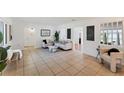 Open-concept living room featuring neutral colors, tile floors and a modern design at 436 Parkview Dr, Sarasota, FL 34243