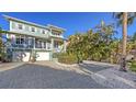 Beautiful two-story home with lush landscaping and brick driveway at 4941 Commonwealth Dr, Sarasota, FL 34242