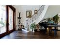 Elegant foyer featuring a grand staircase, hardwood floors, and decorative accents at 511 Bayview Dr, Holmes Beach, FL 34217