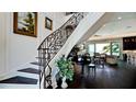Ornate staircase leading to the living area, with dark wood floors and light walls at 511 Bayview Dr, Holmes Beach, FL 34217