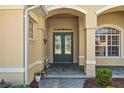 Inviting front entrance with double doors, decorative columns, and manicured landscaping at 5270 White Ibis Dr, North Port, FL 34287