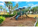 Community playground with slides, climbing structures, and lush greenery, perfect for Gathering fun at 5450 Soapstone Pl # 9-103, Sarasota, FL 34233