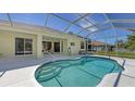 Inviting screened-in pool with a beautiful blue water and tiled patio at 5806 New Paris Way, Ellenton, FL 34222