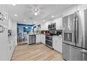 Bright and modern kitchen featuring white cabinets, stainless steel appliances, and tile flooring at 6002 Oak Creek Ln # 1925, Bradenton, FL 34210