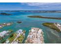 Overhead view showcasing coastal community with waterfront properties, boat docks, and lush green islands in the waterway at 619 Bayview Dr, Longboat Key, FL 34228
