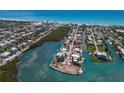Breathtaking aerial shot capturing the community's canal-front homes, clear blue waters, and beach in the distance at 619 Bayview Dr, Longboat Key, FL 34228