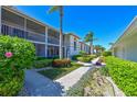 Charming two-story condo featuring beautifully maintained walkway and tropical foliage, ideal for peaceful Florida living at 6912 Drewrys Blf # 608, Bradenton, FL 34203