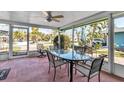 Relaxing screened-in patio with comfortable seating, perfect for enjoying the outdoors at 710 Fox St, Longboat Key, FL 34228