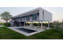 Stunning modern home featuring a private pool, outdoor entertaining space, and lush green lawn at 720 Tarawitt Dr, Longboat Key, FL 34228