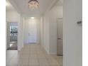 Bright entry hall with tile floors and a decorative chandelier at 7742 Ridgelake Cir, Bradenton, FL 34203