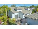 Paver patio features an outdoor seating area surrounded by mature landscaping at 7742 Whitebridge Gln, University Park, FL 34201