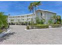 Elegant building with covered parking, and well-maintained landscaping at 100 Sands Point Rd # 225, Longboat Key, FL 34228