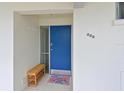 Inviting entrance with bright blue front door, bench, and space to hang coats at 100 Sands Point Rd # 225, Longboat Key, FL 34228