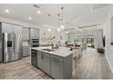 Modern kitchen with stainless steel appliances, a center island, and an open layout, perfect for entertaining at 12130 Seabrook Ave, Bradenton, FL 34211