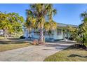 Charming single Gathering home featuring mature landscaping and a cozy, screened in porch at 1224 41St Avenue E Dr, Ellenton, FL 34222