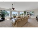 Bright living room features large windows and plush seating at 1311 Triano Cir # 1311, Venice, FL 34292
