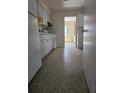 View of the traditional-style kitchen with white appliances and speckled floor at 1778 23Rd St, Sarasota, FL 34234