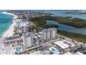 Stunning aerial view of condo buildings near a beach and water, showing the property's desirable location at 2050 Benjamin Franklin Dr # A1001, Sarasota, FL 34236