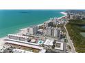 Beautiful aerial view showcases beachfront condos with stunning ocean views, emphasizing a luxurious coastal lifestyle at 2050 Benjamin Franklin Dr # A1001, Sarasota, FL 34236