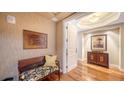 Elegant foyer with wood floors, decorative walls, and a stylish bench, creating a welcoming entrance at 2050 Benjamin Franklin Dr # A1001, Sarasota, FL 34236