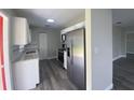 Bright kitchen with stainless steel appliances, granite countertops, and white cabinets at 21114 Gladis Ave, Port Charlotte, FL 33952