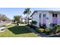 View of condos featuring lush landscaping and well-manicured lawn under a clear sky at 2505 Beneva Rd # 3, Sarasota, FL 34232