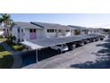 Assigned covered parking spaces with well-maintained landscaping in a condo community at 2505 Beneva Rd # 3, Sarasota, FL 34232