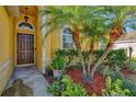 Inviting front entryway with a brown door and tropical landscaping at 3503 14Th E Ct, Ellenton, FL 34222