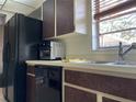 Bright kitchen view featuring a stainless steel sink, dishwasher, and a window offering natural light at 5013 Village Gardens Dr # 34, Sarasota, FL 34234