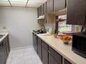 Efficient kitchen features light countertops, ample cabinet space, and modern microwave at 5013 Village Gardens Dr # 34, Sarasota, FL 34234