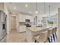 Spacious kitchen with stainless steel appliances, granite countertops, and a breakfast bar at 507 W Cashew, Punta Gorda, FL 33955