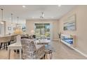 Bright living room featuring tile floors, stylish furniture, and sliding glass doors to the outdoors at 507 W Cashew, Punta Gorda, FL 33955