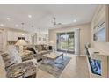 Bright living room with tile flooring, comfortable seating, and access to the outdoor patio at 507 W Cashew, Punta Gorda, FL 33955