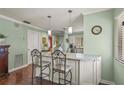 Kitchen island featuring granite countertops and pendant lighting with seating for two at 5275 Willow Links # 50, Sarasota, FL 34235