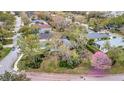An aerial perspective highlights a lovely home surrounded by mature trees in a quiet neighborhood at 5508 Whitehead St, Bradenton, FL 34203