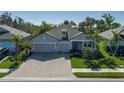 Lovely single-Gathering home with a paved driveway and lush tropical landscaping at 5621 Badini Way, Palmetto, FL 34221
