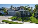 Beautiful single-story home with a well-maintained lawn and mature landscaping at 5621 Badini Way, Palmetto, FL 34221