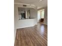 Spacious living room with wood flooring, open layout, and natural light at 5681 Bentgrass Dr # 13-201, Sarasota, FL 34235